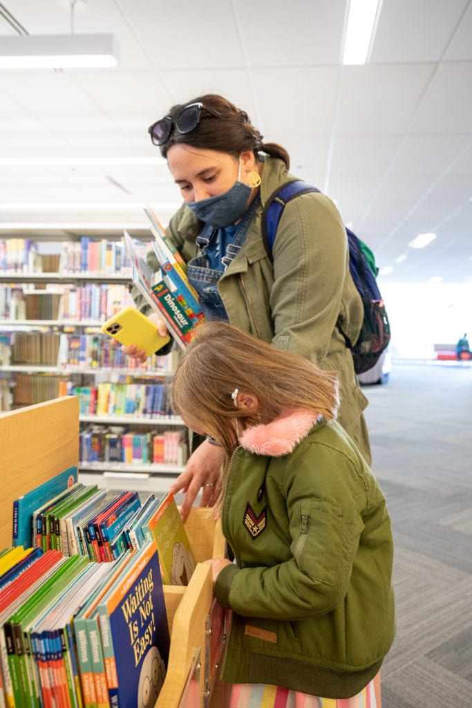 Fmaily browsing books Inside the Columbus public main library.