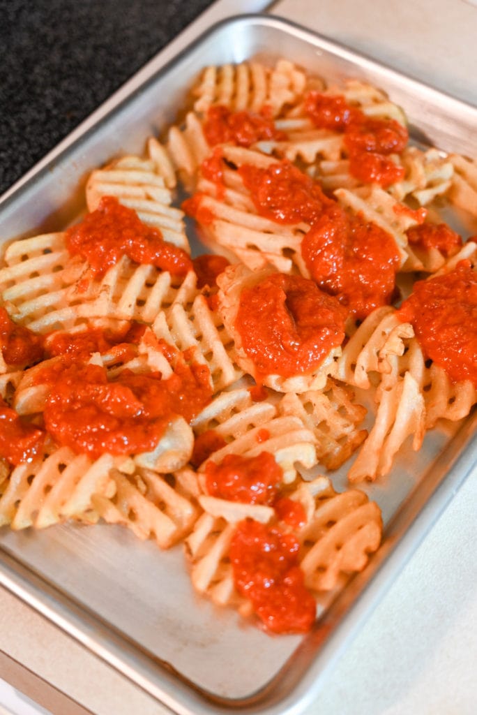 frozen waffle fries get topped with pizza sauce.