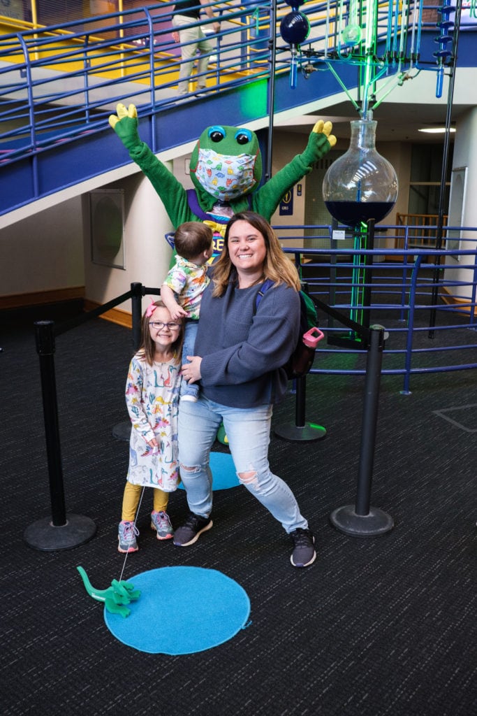 Family posing with a character inside of the Children's Museum Of Indianapolis.