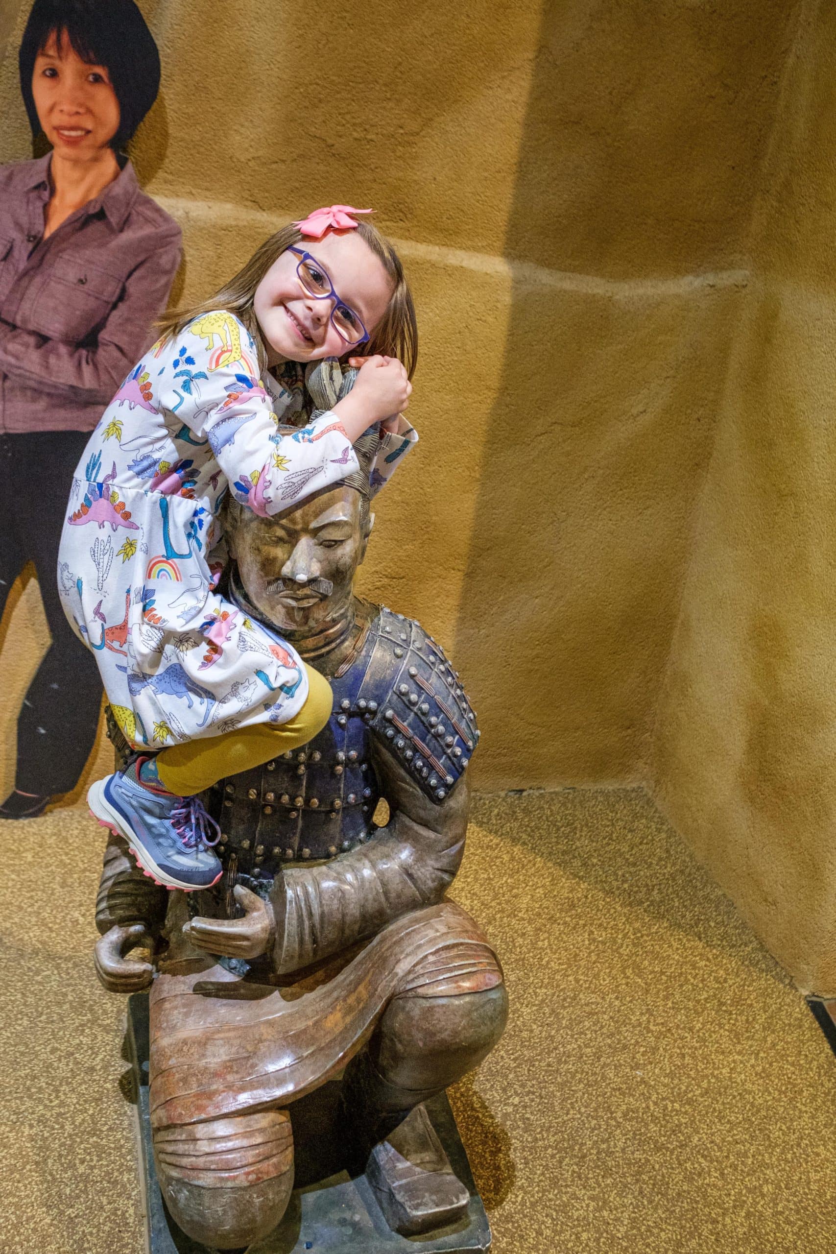 Child climbing a statue in a play area at the Children's Museum Of Indianapolis.