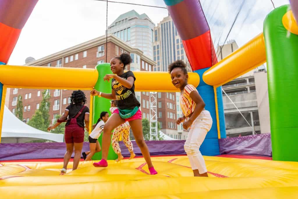 Kids in bounce house at Columbus Commons.