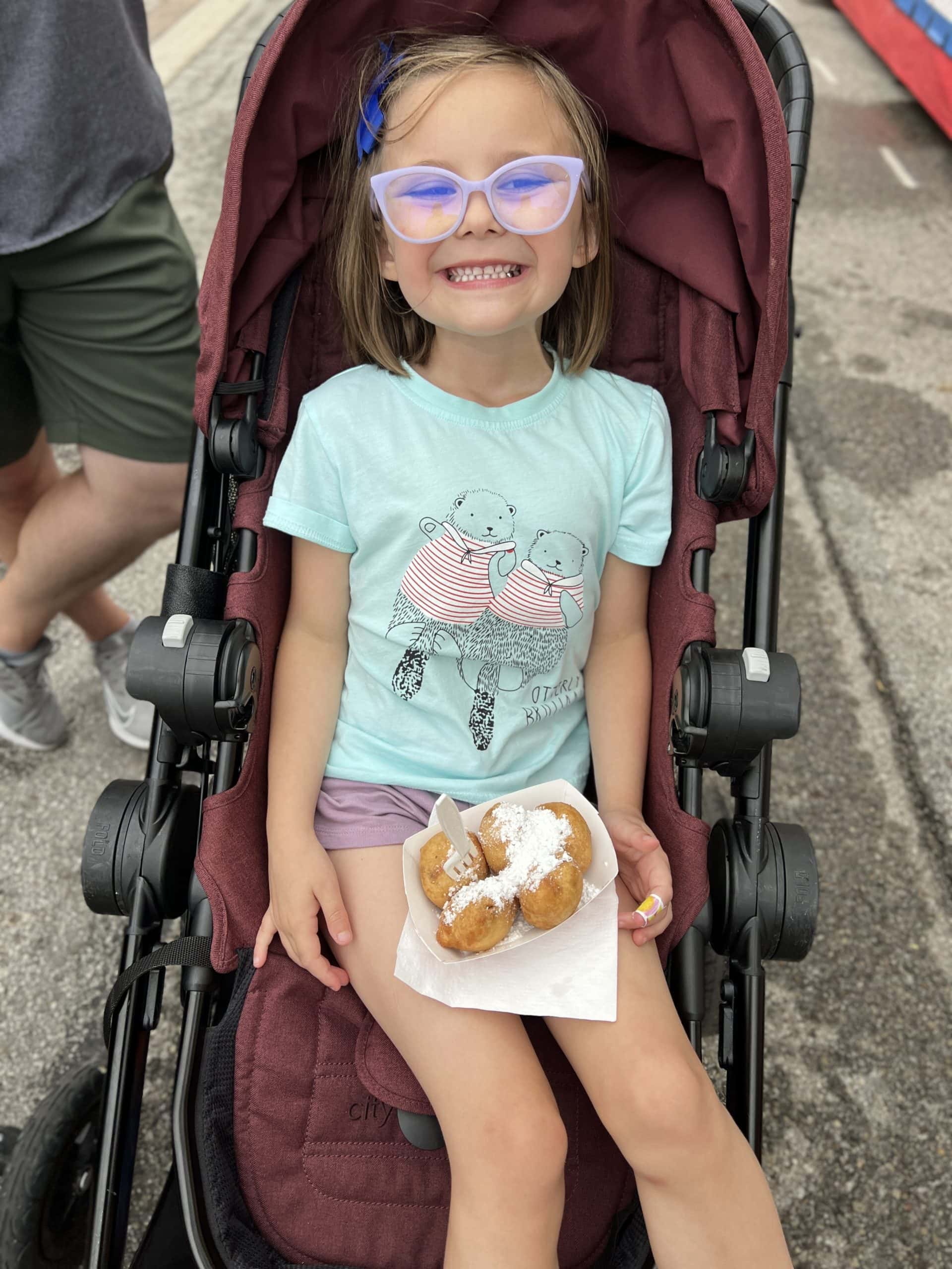 Girl enjoying fried Oreos are the Ohio State Fair.
