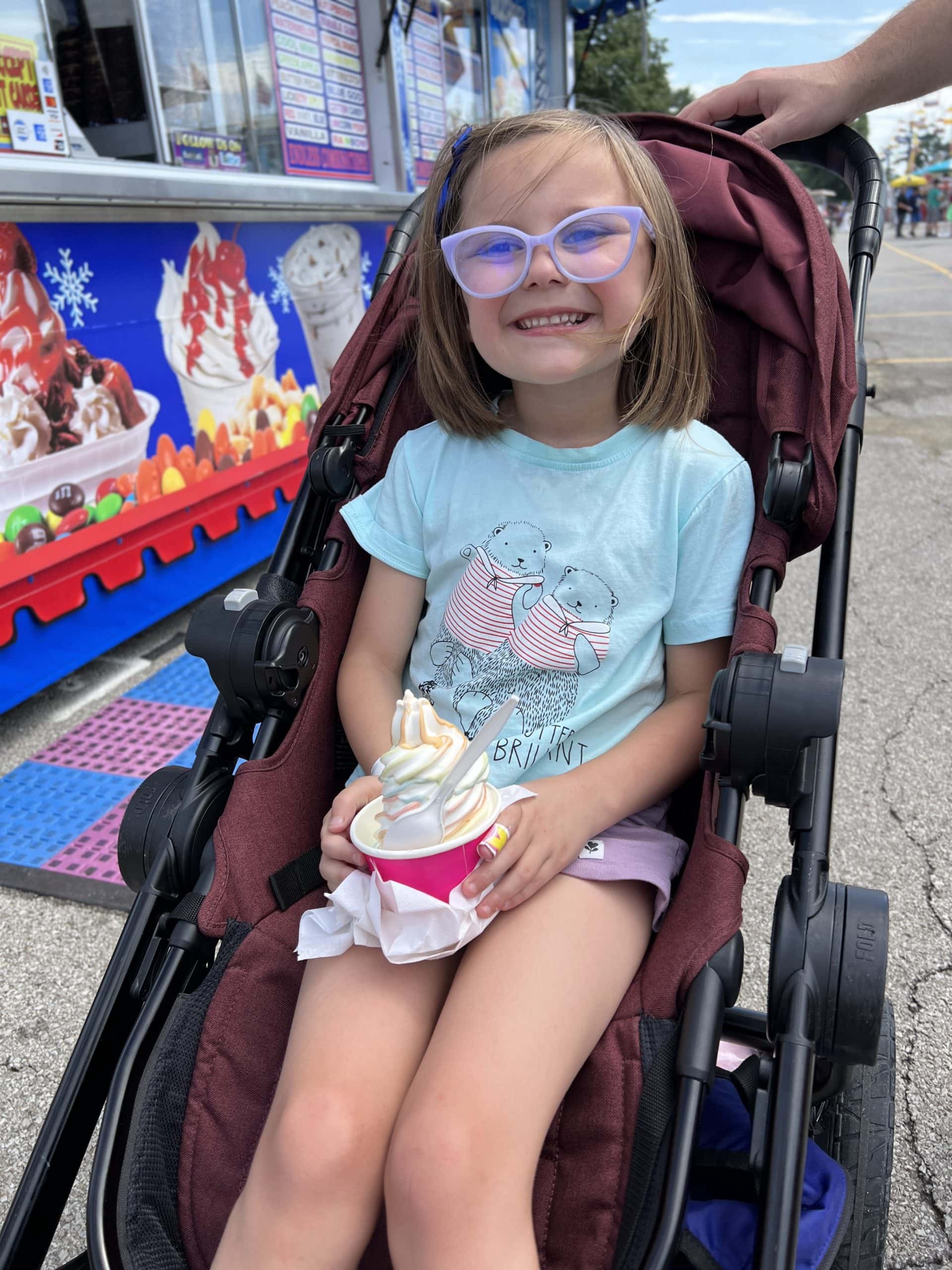 girl enjoying flavor burst ice cream at the Ohio State Fair.