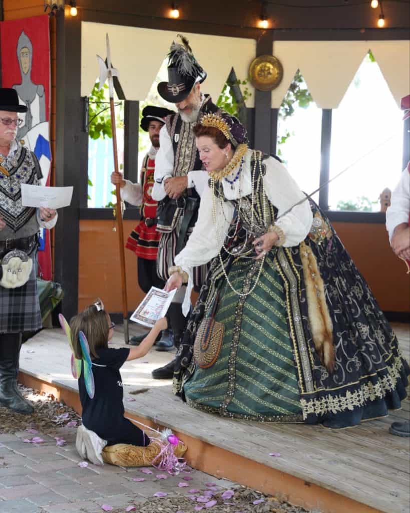 The Queen at the Ohio Renaissance Festival crowning a child during the fun ceremony.