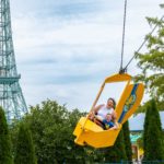 Mom and daughter enjoying the woodstock flyer ride at Kings Island in Mason, Ohio.