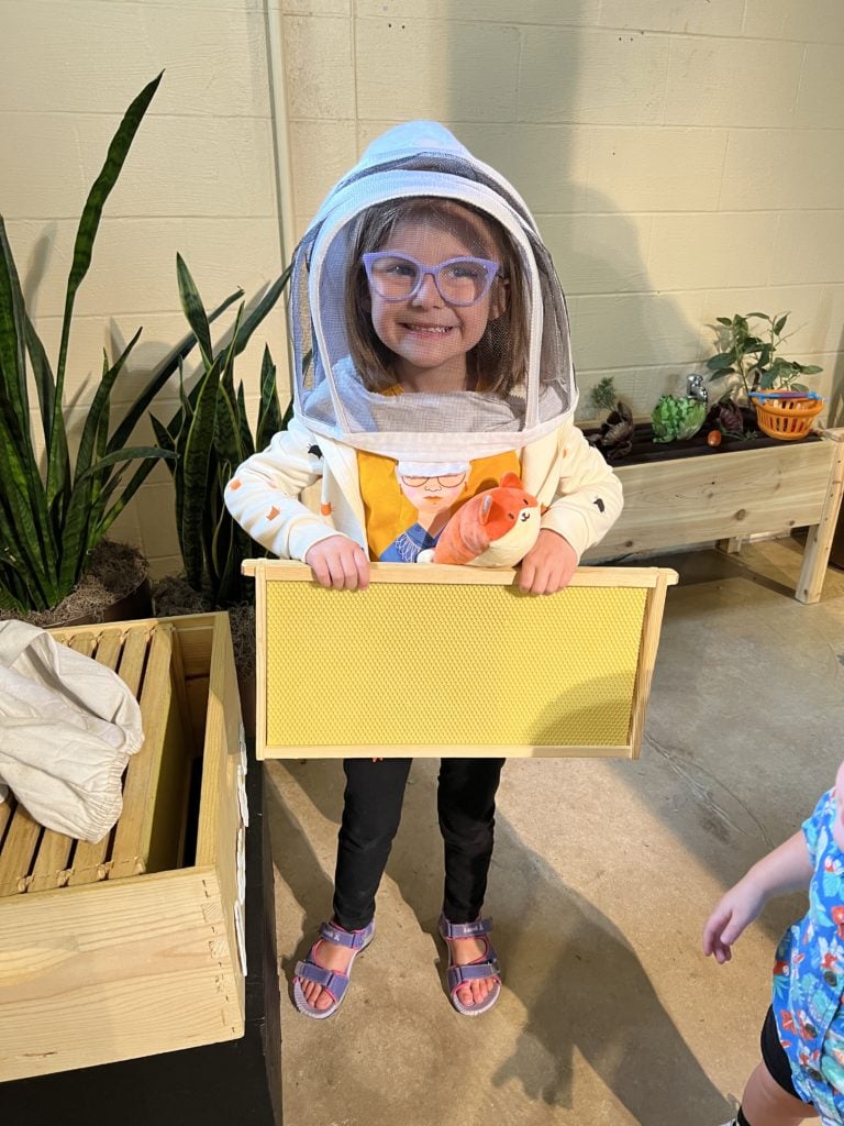 Child dressed as a beekeeper at Franklin Park Conservatory. 