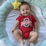 Cute baby wearing OHIO STATE football onesie.