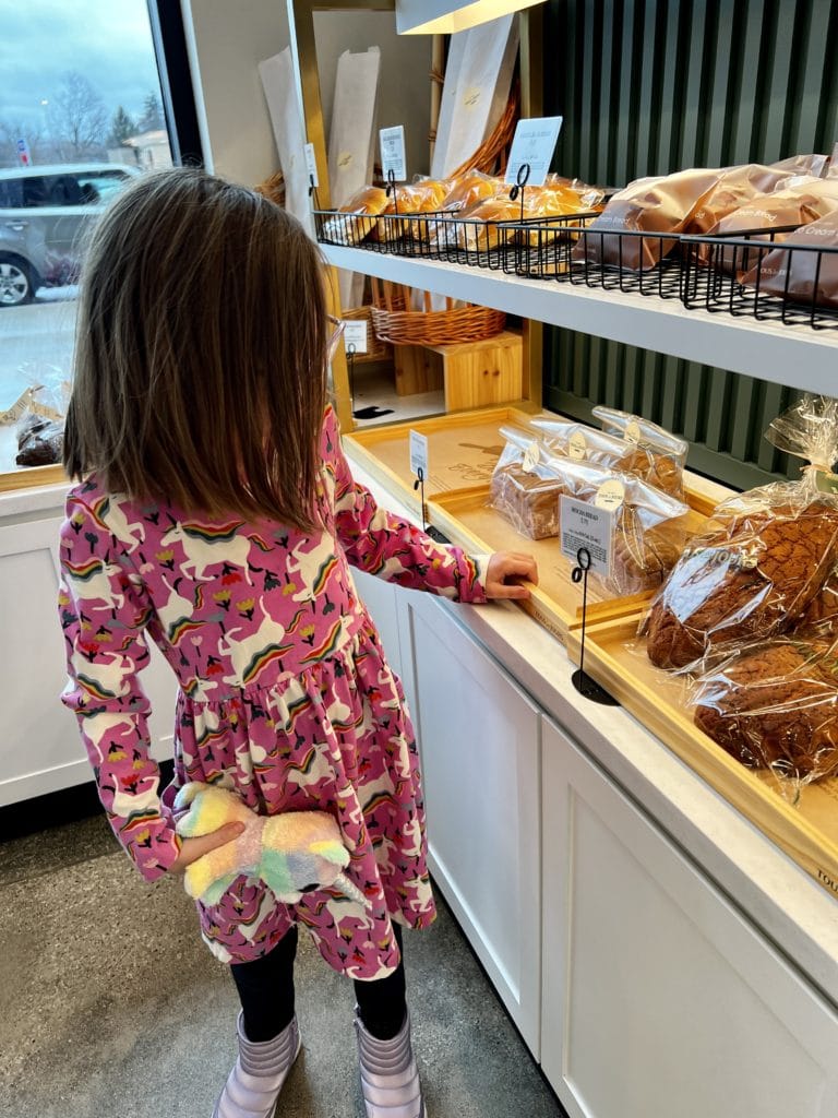 Young girl admiring the breads at TOUS les JOURS new location in Columbus,OH.