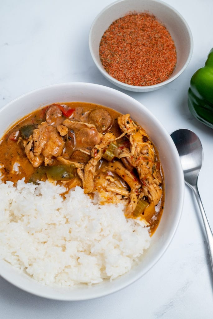 Spicy chicken gumbo recipe served in a bowl alongside white rice.