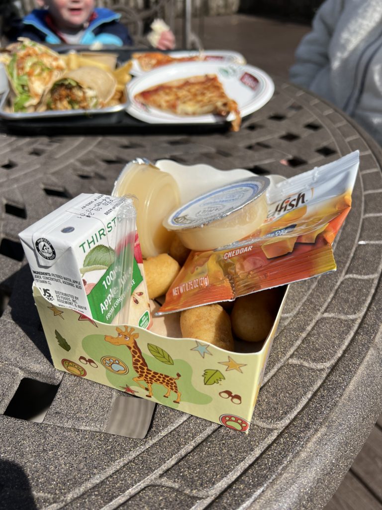 Kid's Meal with mini corn dogs, goldfish, and apple juice.